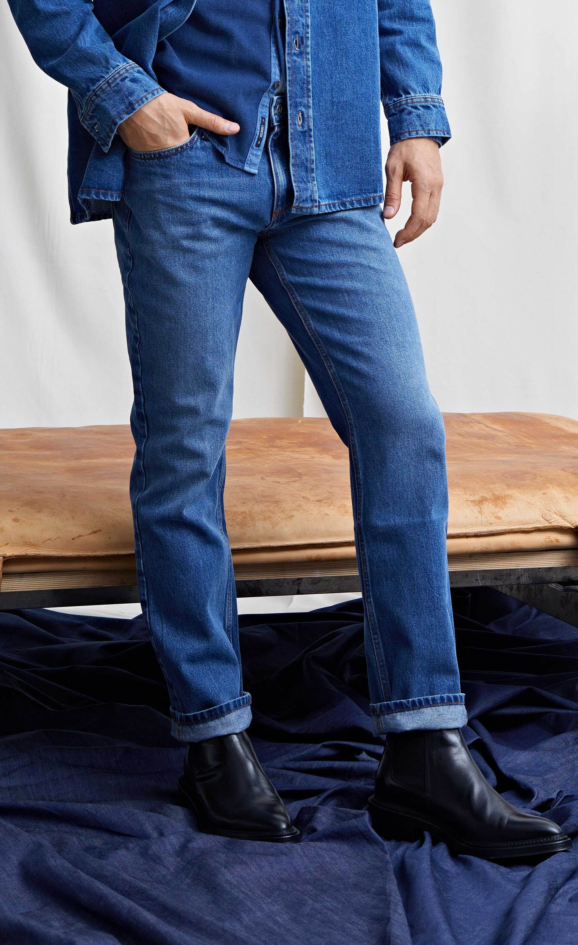 Model i blå, tapered fit Lindbergh jeans og blå Lindbergh denimskjorte